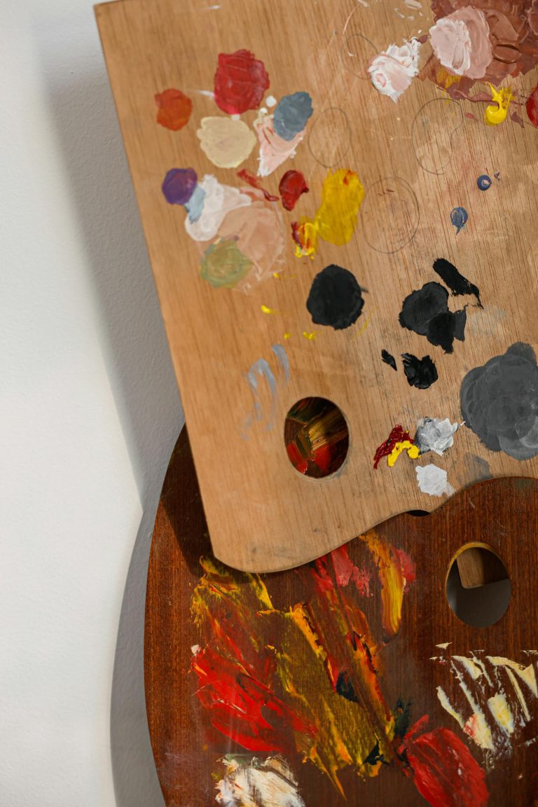 Close-up of colorful paint palettes showcasing a variety of artistic hues and textures.